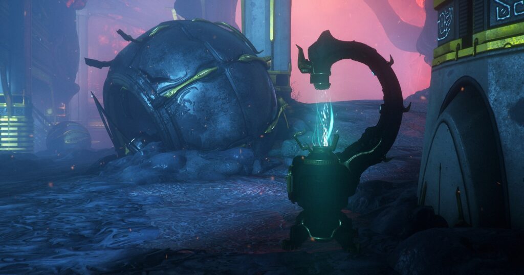 A screenshot of an Orokin device, consisting of a squat round base with an arm that branches out from the side before arching back towards the main unit, with a small receiver at the end of the arm positioned directly over the base. A conduit of cyan energy flows between the base and the receiver. The device is located within the Deimos underground tunnels, and the ruins of defunct Entrati machinery can be seen in the background. Screenshot by GrayArchon.